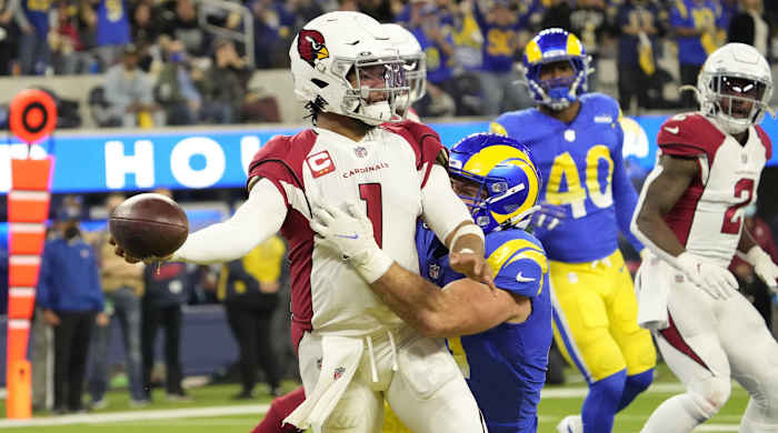 Arizona Cardinals quarterback Kyler Murray (1) throws the ball while brought down (57) during the second quarter of the NFC Wild Card playoff game.